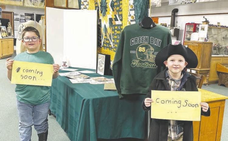 Blane and Brady Biegler and their mom, Kaleigh, are putting together a Tucker Kraft/Green Bay Packers exhibit at the Timber Lake Museum, which will be finished soon. Photo by Kathy Nelson