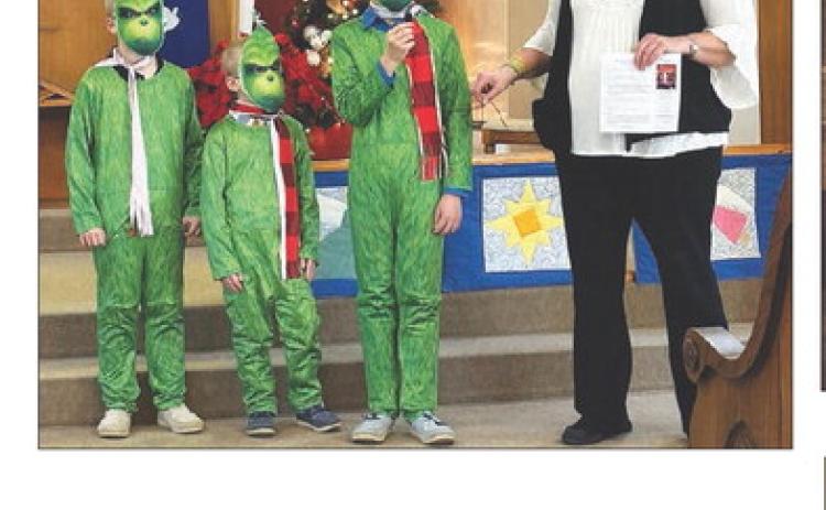 The Zeug brothers (Eli, Andrew and Isaac) took the message “Jesus is not a Grinch” to the Timber Lake Christmas parade and won first place for United Parish Church. They appeared briefly with Vicar Teri Gayer at church on Sunday.