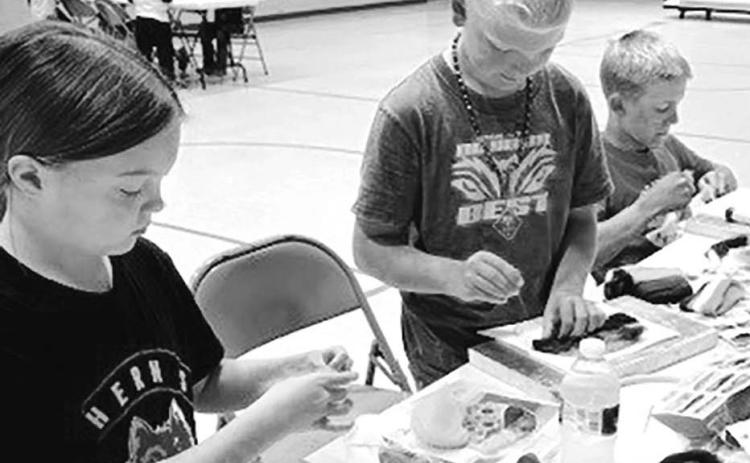 (L-R): Zoey Spiel, Eli Zeug and Isaac Zeug work patiently on their needle felting projects.