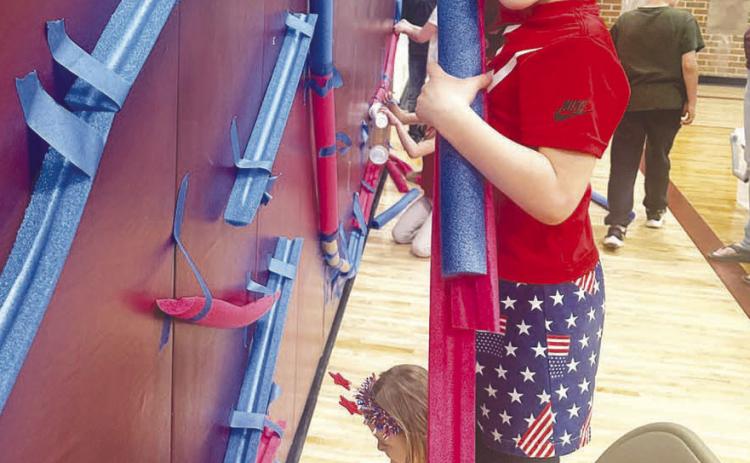 Canyon Quaschnick practices building a marble run.