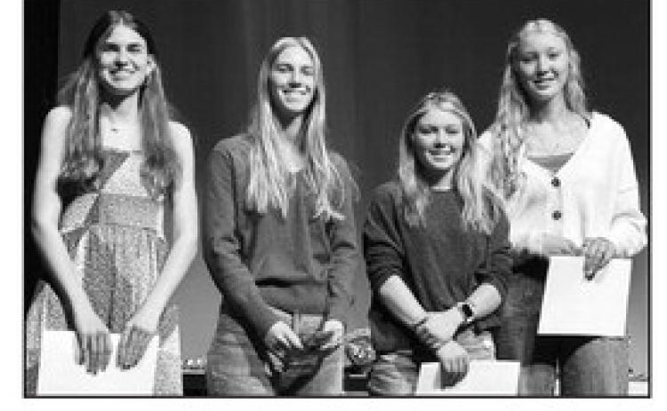 Junior Meredith Maciejewski (left) received a bronze award for her interactive bulletin board, and seniors (l-r): Averie Marshall, Kenlea Heck, and Kendyl Locken received honor cords to wear at graduation.