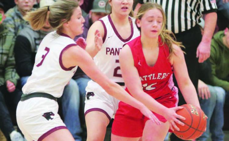 Lady Panther defenders Carlie Lawrence (3) and Abby Linderman utilize a half-court trap press to tie up Potter County’s Ashlee Kaup and ultimately force a turnover during first half action of Timber Lake’s win over the Battlers last week. Photo by Jon Flatland