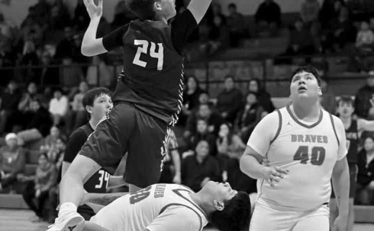 Timber Lake’s Kanton Hunt (24) drew a charging call after colliding with Cheyenne-EagleButte’s Danah Diver on a drive to the basket during inter-county boys basketball action in Eagle Butte last Tuesday, Feb. 18. Looking on for C-EB is Easton Lawrence (40) Photo by Marie DuPreez
