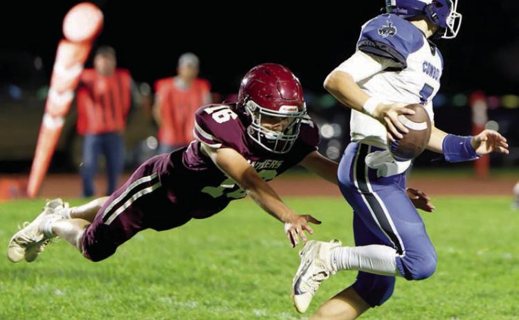 Sophomore Cooper Keller (16) makes a diving tackle on Lemmon-McIntosh quarterback Max Anderson during Timber Lake’s 46-28 Homecoming win over the Cowboys. The Panthers, 2-4 on the season, square off against 0-6 Gettysburg this Friday, Oct. 10. Photo by Marie DuPreez