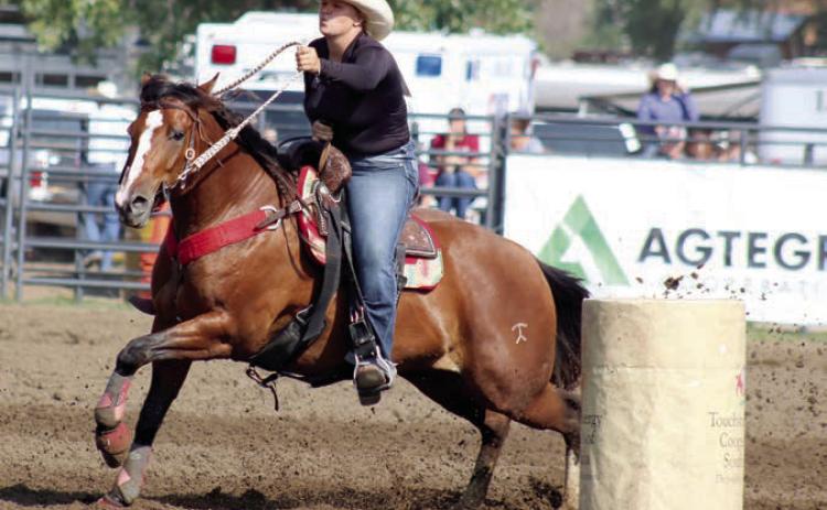 Photo by Jon Flatland Hope Kiel of Glenham, shown here competing in barrel racing, set a new arena record in the ladies breakaway roping event at the South Dakota 4-H State Finals Rodeo last weekend in Aberdeen, posting a blazing 1.5 second run.
