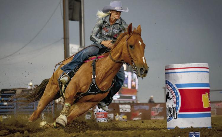 Summer Kosel of Glenham guides her horse around a barrel at the Killdeer Mountain Round-Up Rodeo held July 1-4 in Killdeer, SD. Kosel placed 13th in Killdeer but bounced back to win the barrel racing championship at the Sitting Bull Stampede Rodeo in Mobridge July 3-4. Photo courtesy of Chuck Miner/4C Photography