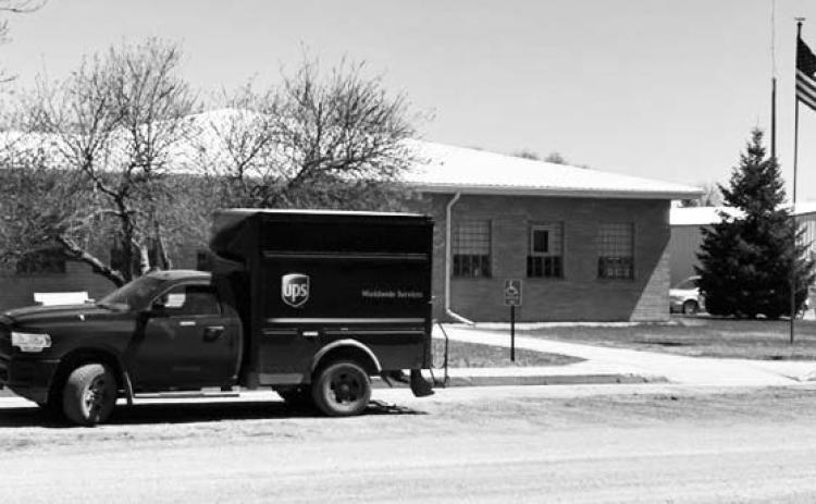 A United Parcel Service (UPS) truck sits in front of the Dewey County Courthouse in Timber Lake on Tuesday, May 2, while the driver delivers a package inside. As of Monday, May 1, UPS cut its deliveries to rural West River communities from five days to three days per week. The communities of Timber Lake, Isabel, Dupree, and Eagle Butte are among those affected by the cuts. Photo by Jon Flatland