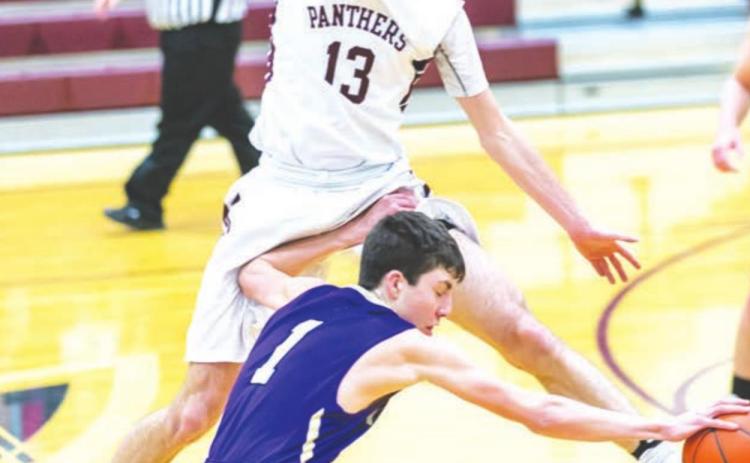 Kadoka Area’s Cole O’Bryan dribbles past a leaping Hunter Schrempp of Timber Lake during boys basketball action last Tuesday. The Panthers earned a 56-46 victory with Schrempp contributing 10 points and a handful of rebounds. Photo by Robert Slocum