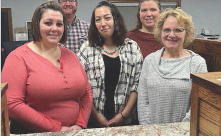 Staff at Western Dakota Bank (FRONT) L-R: Jennifer Bollinger (cashier), Amy Taylor (teller), Karma Nash (senior vice-president); BACK: Rusty Gebhardt (senior vice-president) and Kayla Kennedy (teller). President John Templer is not pictured but plans to attend the grand reopening. Photo by Jon Flatland