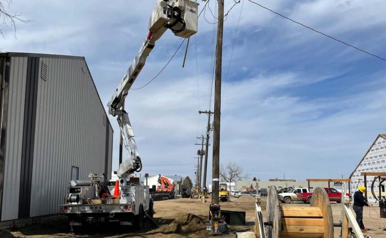 ABOVE: A Moreau-Grand crew gets ready to move a pole in the alley of Block 17 behind the post office.