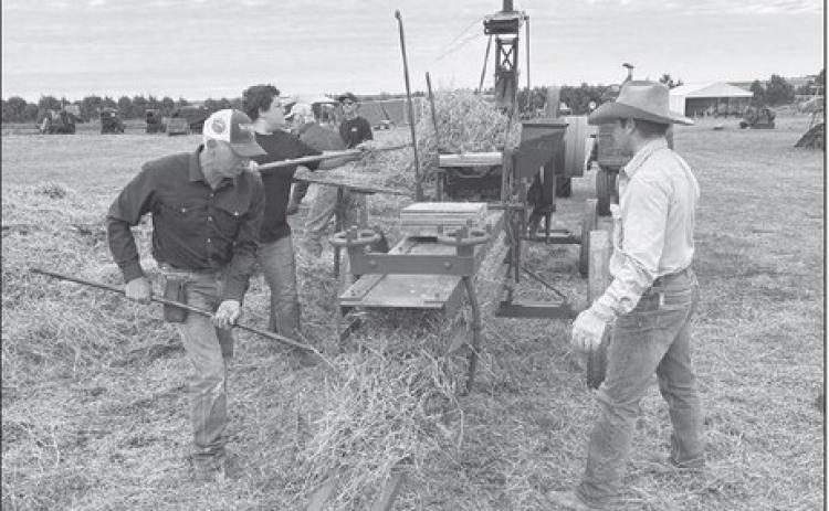 Brian Flatmoe and Teigan Clark of Meadow, Joseph Sterling, Menno, and Brad Hatle, Lemmon, operating the International Harvester Stationary Baler at the Coal Springs Antique Show and Threshing Bee near Meadow last weekend. As always the event drew hundreds of people from across the state and midwest.