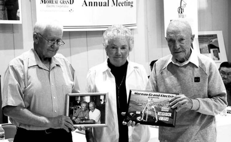 Moreau-Grand Electric board president Larry Hieb (EFT) presents the Good Neighbor Award to Keva and Andy Aberle of Timber Lake at the M-G annual meeting.