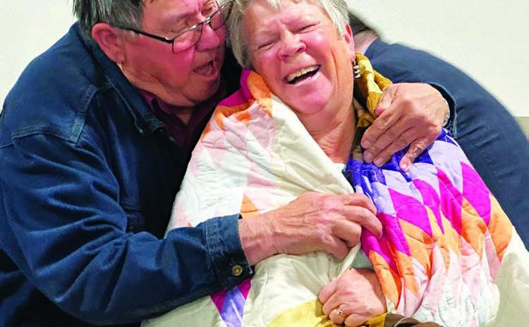 Board member Paul Lawrence presents out-going MGEC Manager Melissa Maher with a star quilt during the cooperative’s 78th annual meeting last Wednesday, Oct. 9. Photo by Kathy Nelson