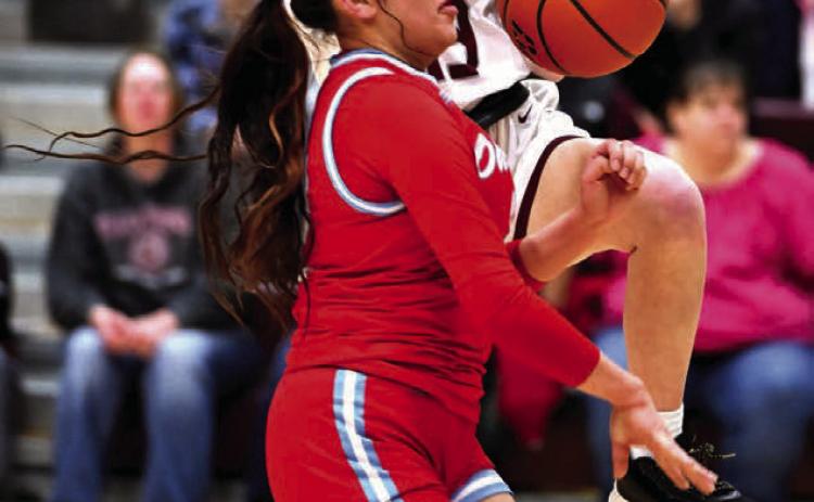 Sophomore guard Sara Keller is fouled by a Cheyenne-Eagle Butte defender as she drives for a layup during recent girls basketball action in Timber Lake. The Lady Panthers advanced out of the first round of the Region 8B Tournament last week but were eliminated in the second round by undefeated and third-ranked Harding County Photo by Marie Du Preez