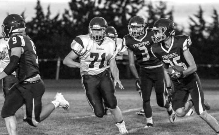 Timber Lake senior Hunter Schrempp (26) runs with the ball as teammates Hank Kraft (9) and Chazz Gabe (3) look to block during their home victory over Newell on Friday. Photos by Jon Flatland