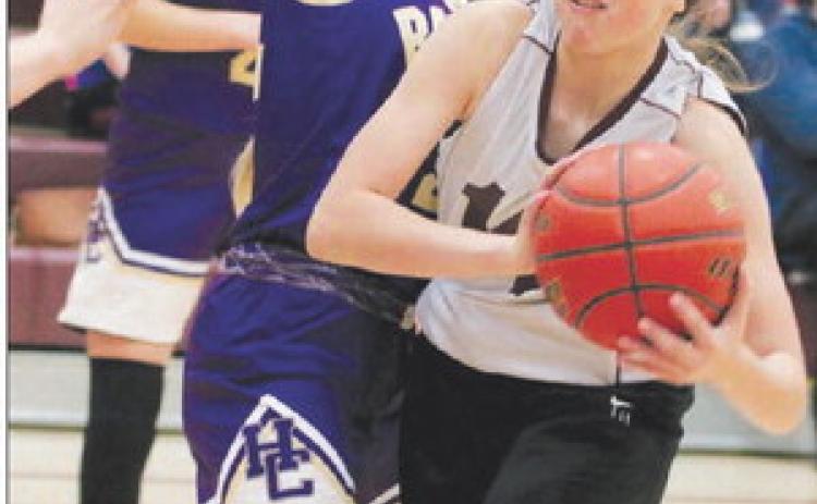 Timber Lake’s Jaylee Schoelerman takes a body check from a Harding County defender while driving the lane during the 2022 LMC Middle School Girls Basketball Tournament on Saturday, Dec. 3. Timber Lake finished third and Harding County was runner-up to Lemmon. Photo by Jon Flatland