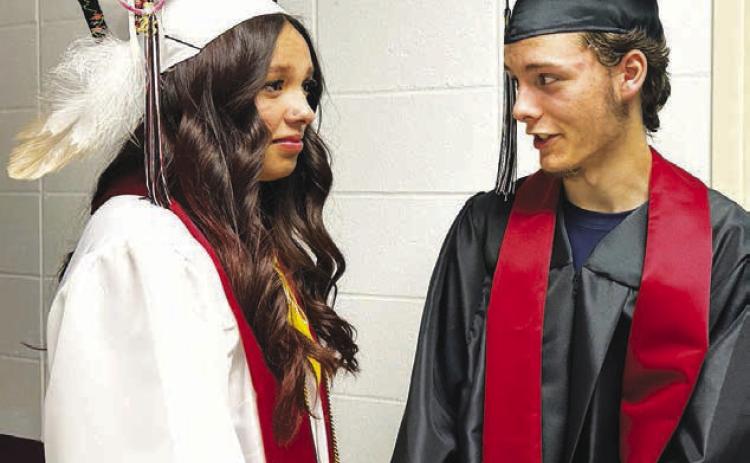 Seniors Kessa Bigger (left) and Matthew Bowlby await their cue to enter the gym at the Timber Lake High School graduation ceremony on May 10.
