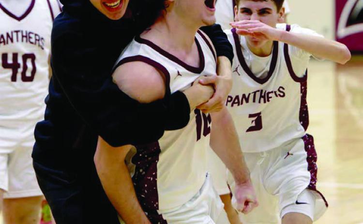 Treyden Beer (10, middle) gets mobbed by his teammates after draining a 15-foot buzzer-beater to give Timber Lake a 52-50 win over North Central on Saturday, Jan. 31. Included in the celebration were Mason Bickel (40), Braden Lawrence (3), and Jackson Bigger (in black). Topic Photo/Marie DuPreez
