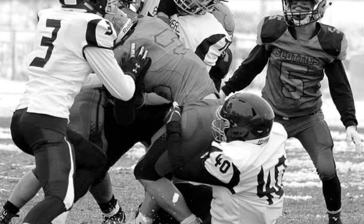 Panther defenders Chazz Gabe (3) Patrick Marshall (77) and Jaiden Ducheneaux (40) gang up on a Philip ball carrier during their 9-man playoff football game last week. Photo by Chelsea Tobin, Philip Pioneer Review