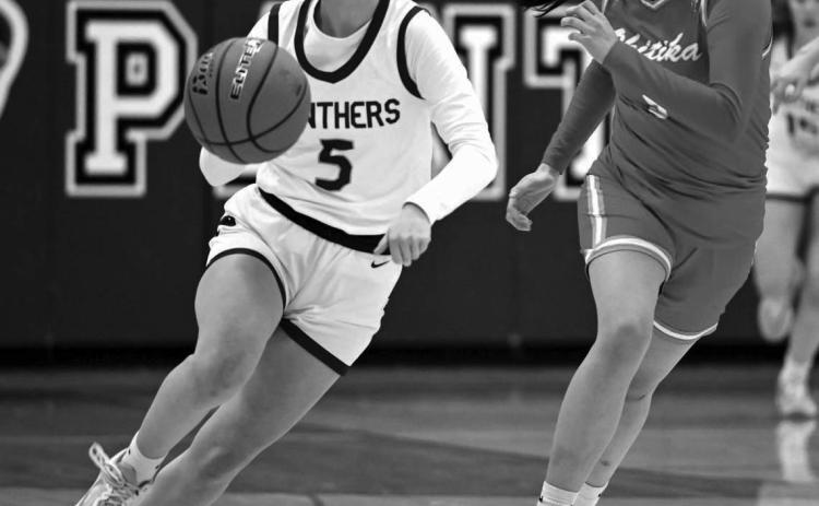 Panther senior Averie Marshall pushes the ball up-court during recent action against an unidentified Cheyenne-Eagle Butte defender during recent action. The Lady Panthers won the battle for bragging rights in Dewey County 52-37. Photo by Marie Du Preez
