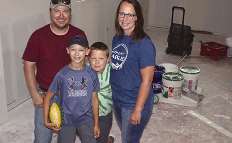 Chance and Merretta Anderson, shown with sons Gus and Hank, have purchased the former Masonic Lodge in Isabel and are currently remodeling the building to become the new home of Red Earth Table, an expansion of their already successful home-based bakery. They plan to open the bakery and breakfast diner this fall. Photo by Jon Flatland