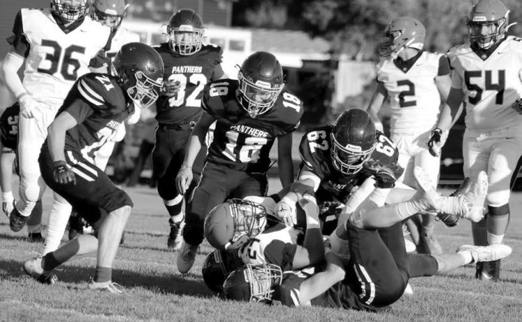 Timber Lake linebacker Cole Ducheneaux (on the bottom of the pile) gets an assist in tackling a Philip runner from Treyton Du Preez (62) as Brody Ellison (18) and Eddie Keller (21) move in and Gabe Keller (32) trails the play. The Panthers will attempt to break out of two-game losing streak when they host North Central on Friday, Sept. 6, in a 6 pm kickoff at Kraft Field. Photo by Jon Flatland