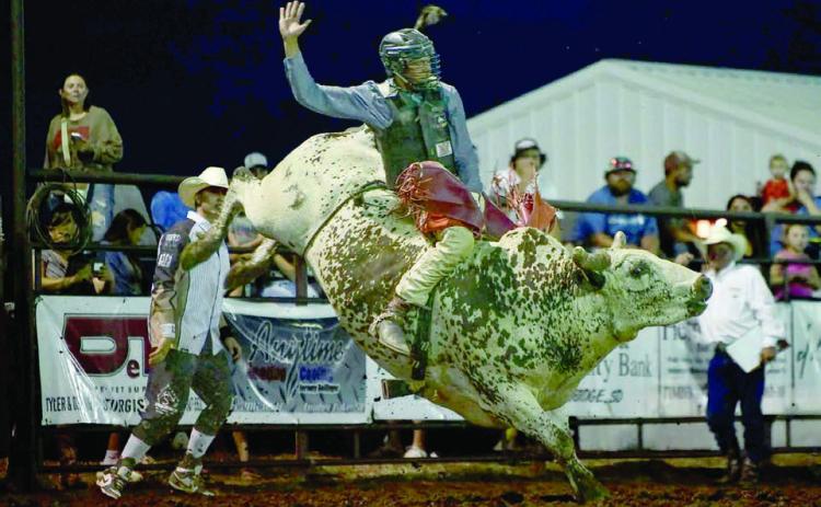 Left, Chazz Gabe of Timber Lake scored 82 points to win the bull riding event at the Herreid Rodeo last weekend. Gabe currenly leads the South Dakota Rodeo Association standings. Photo by Chuck Miner