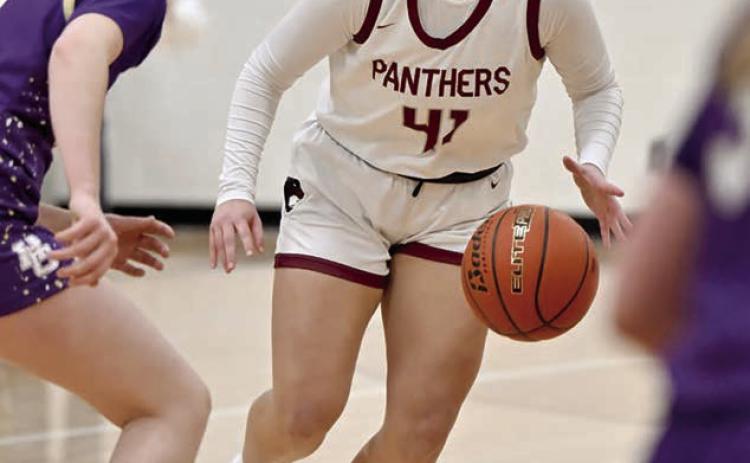 Eighth grader Madalyn Hermes looks for an opening in the Harding County defense to drive the lane during Timber Lake's battle with the Ranchers last week. The Lady Panthers were upon the Ranchers early, but unbeaten and state-ranked Harding County battled back for the win.