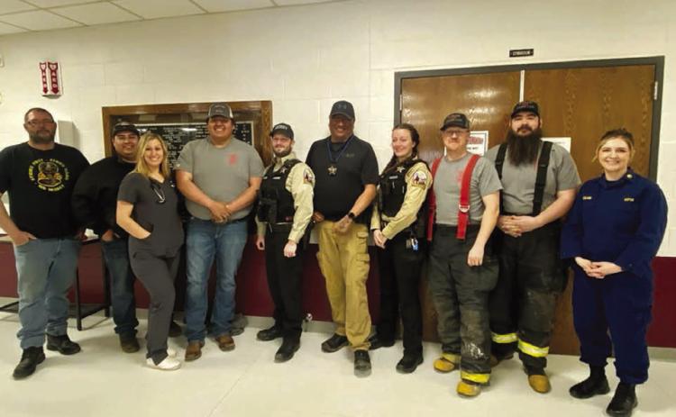 Community heroes honored at Timber Lake Elementary on March 21 included these firefighters, EMTs, law enforcement officers, county road crew, and nurses. L-R: Justin Webb, Will Wiedmer, Rachael Goldade, Keith Jewett, Kyle Nilson, Ash Arpan, Trista Bulit, Brent Gill, Shad Bollinger, and Veronica Handeland.