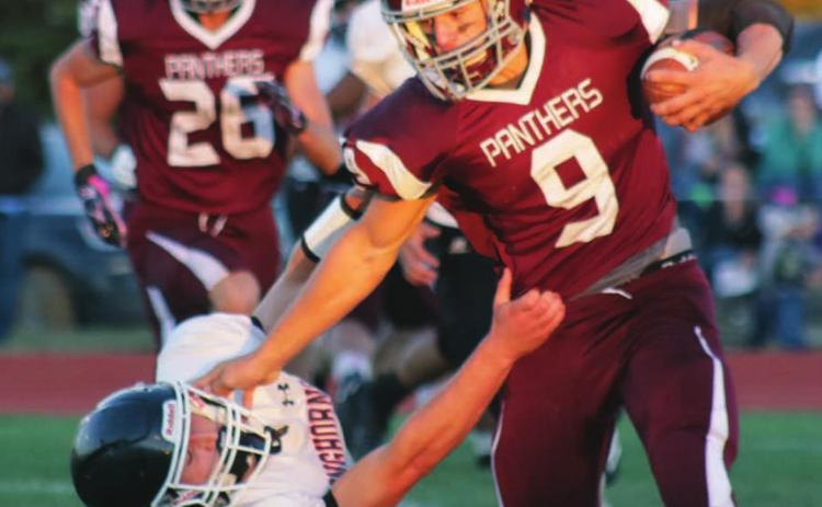 LEFT: Timber Lake running back Hank Kraft stiffarms a Faith Longhorn defender during a run on Friday night in the Panthers’ home opener. Kraft caught three touchdown passes and ran for another in the 64-14 victory.