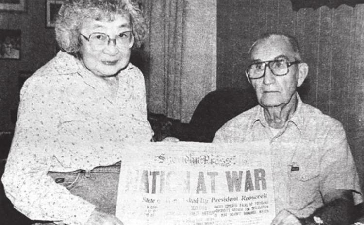 Jim and Mary Byington with the front page of the Sheridan Press