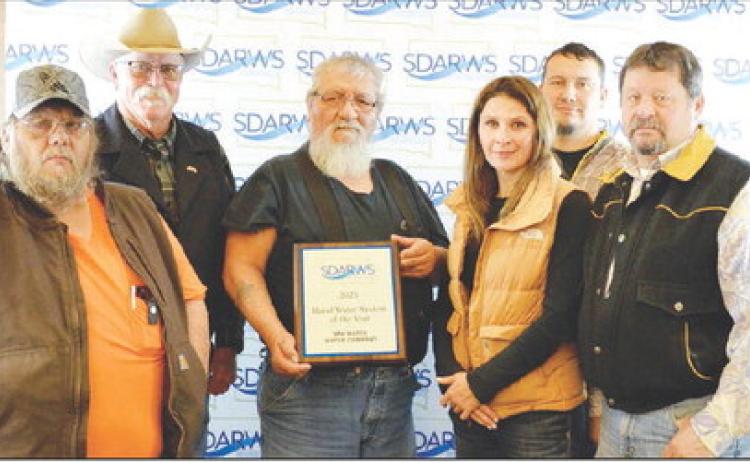 Accepting the Rural Water System of the Year Award were (l-r) Eddie Longbrake, employee; Bob Booth, board VP; Rolland Collins, board president; Lacy Maher, employee; Danny Marshall, employee; and Leo “Earp” Fischer, executive director. Not pictured are board members Oren Lesmeister, Rhae Washburn, Dave Hump and Lynn Williams.