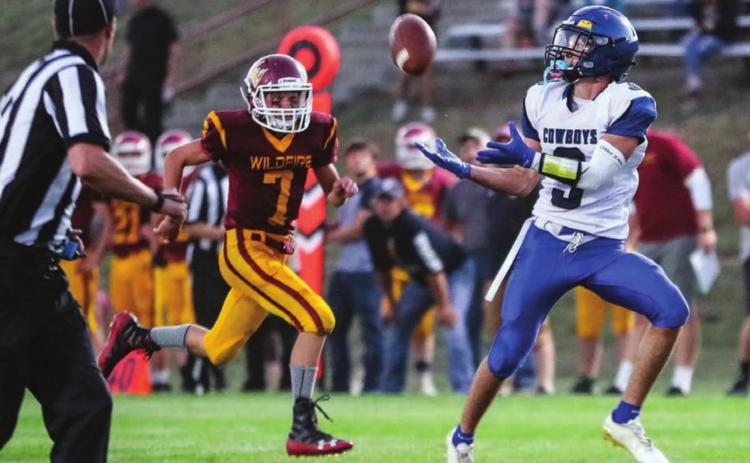 Lemmon-McIntosh’s Isaiah Portwood (3) catches a long pass from Cody Thompson before he runs it in for a touchdown during the Cowboys’ season opening win over Mott-Regent-New England in Mott Friday.