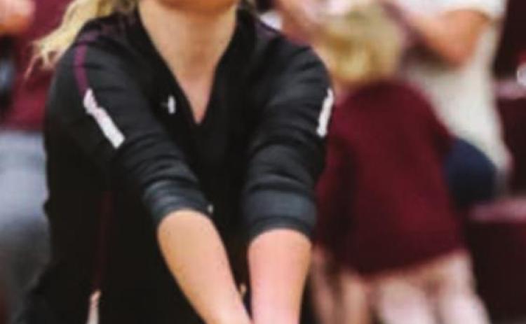 Bailey Keller fields a serve in recent varsity volleyball action.