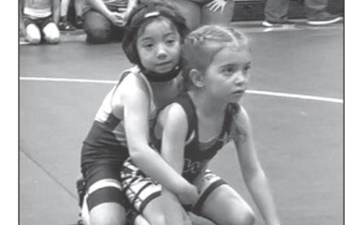 Ramzi Veit, left, was among the gold medal winners at the Mobridge Youth Wrestling Invitational held Sunday, Feb. 11. Ramzi took top honors in the Girls Tots 38-39 division. Eight member of the Timber Lake Youth Wrestling Club earned top spots on the winners podium. Courtesy Photo