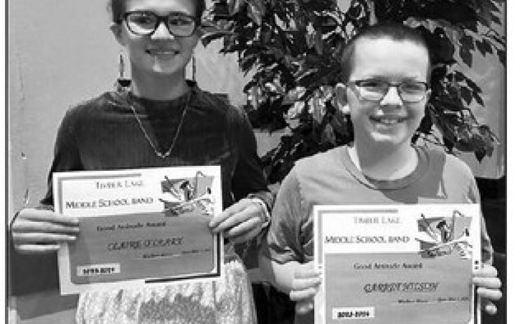 Claire O’Leary (left) and Garrett Nilson received the Good Attitude Award from music teacher Walker Rose.
