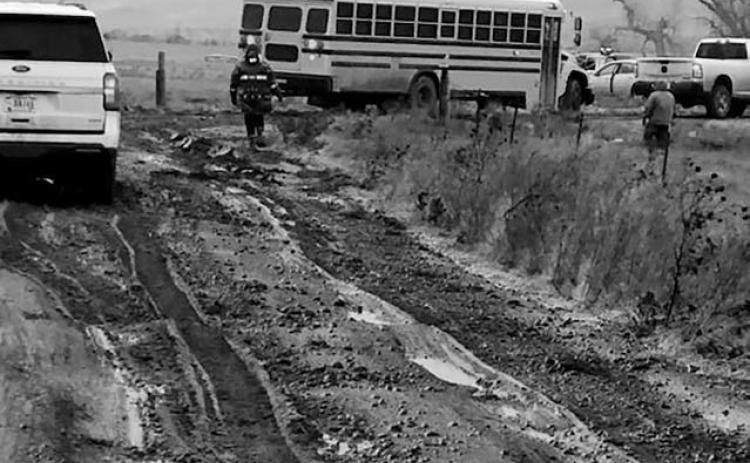 Volunteers had to be called in to push out a Takini School bus that became stuck on one of the nearly impassable roads in the Cottonwood area on Tuesday, Nov. 25. No students were on the bus at the time it became stuck. Schools across the area cancelled classes and activities on Tuesday due to dangerous travel conditions.