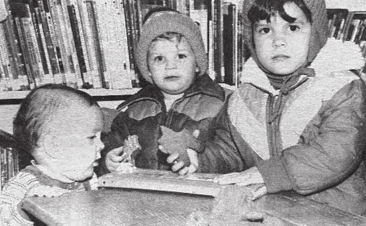At the library Cassie, Beaman and Chasity Kraft munch on gingerbread men after the Christmas movies at the library Saturday. About 20 children and mothers attended the showing. Cassie and Chasity are the daughters of Mike and Donna Kraft. Beaman is the son of Dave and Mary Lou Kraft. Timber Lake Topic, December 24,1981