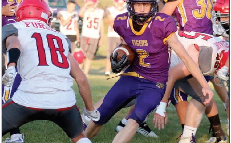 A wide-eyed Cruz Birkeland (2) puts a move on a Potter County defender during the Dupree Tigers 56-6 win over the Battlers at Tiger Field last Friday, Sept. 13. Birkeland, a junior running back and linebacker, had a career day, scoring five rushing touchdowns and a defensive TD when he scooped up a blocked Potter County punt and took it into the end zone. Photo by Jon Flatland