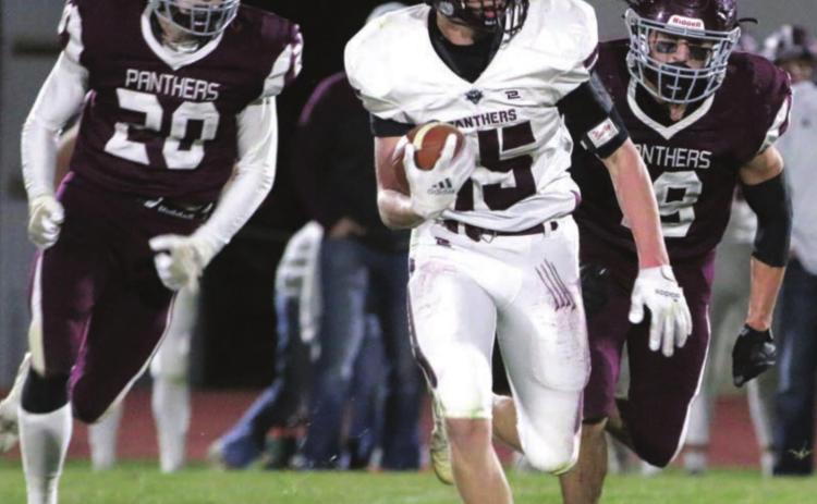 Timber Lake defenders Thane Keller (20) and Jayce Lawrence (19) chase a Platte-Geddes ball carrier during their state semifinal football game in Timber Lake. Photos by Jon Flatland