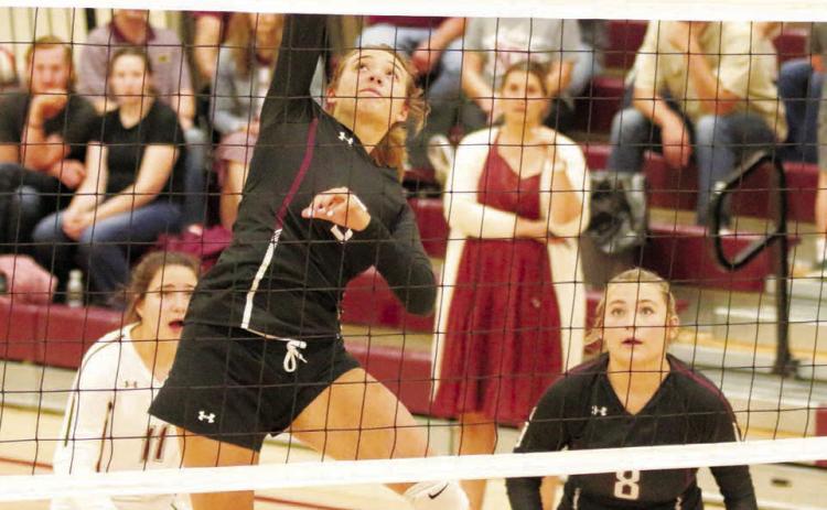 Timber Lake senior middle hitter Shay Kraft hammers a spike toward the Cheyenne-Eagle Butte Lady Braves during their matchup in Timber Lake last Tuesday, Aug. 30. Looking on are Kenna Webb (8) and liberio Abby Linderman (11). Photo by Jon Flatland
