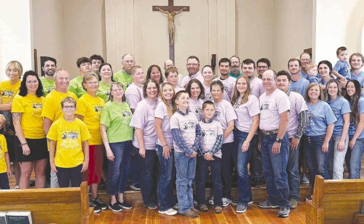 The Robert and Grace Alley children held a family reunion in Isabel on August 1 with 44 members present. This is the first time all the siblings have been together with their children and grandchildren. All 11 siblings graduated from Isabel High School along with their mom, Grace Whitehead Alley, and Mary's four children. Pictured are: Patty's family in yellow; John's family in green; Mary's family in purple; Tim's family in blue; back row, Bob in grey and Mark in green.