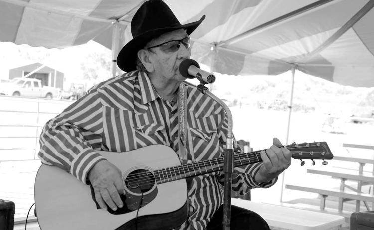 Warming up the audience prior to the Days of 1910 Talent Show under the big tent on Main Street last Thursday, July 24, was White Horse balladeer Frankie Thompson, a favorite among local residents. Thompson sang from his set list and also took requests from the audience. Photo by Jon Flatland