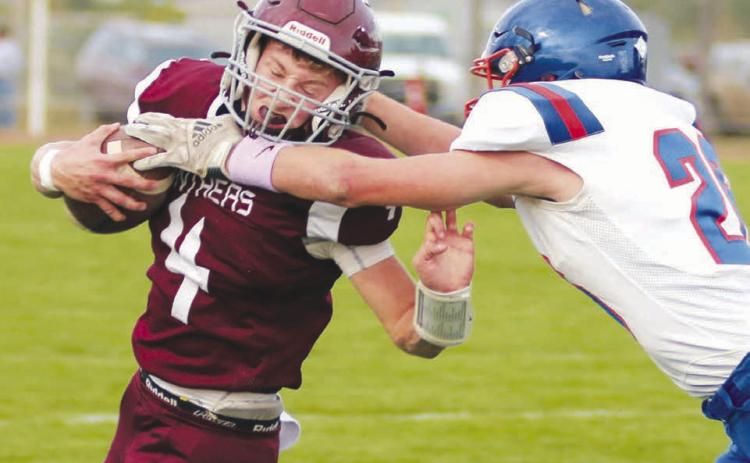 Timber Lake quarterback Gracen Hansen grimaces as he takes a high hit from Jones County linebacker Adrick Schoon during the Panthers 46-6 win over the Coyotes last Friday at Doug Kraft Field. Hansen finished the contest with three touchdown passes to go along with a TD run. Timber Lake, 4-1, travels to Faith to take on the 4-1 Longhorns on Friday, Sept. 23. Photo by Jon Flatland